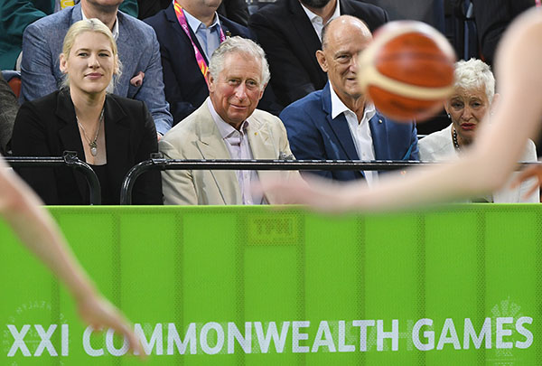 Britain's Prince Charles (with former Australian and WNBA basketball player Lauren Jackson to his right) during the India V New Zealand women's basketball game at the Commonwealth Games, Cairns - image by Brian Cassey